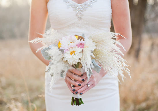 Bride holding wildflowers and pampas grass bouquet