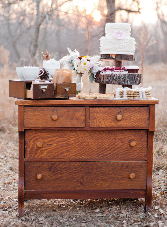 Vintage dresser adorned with cake and treats outdoors