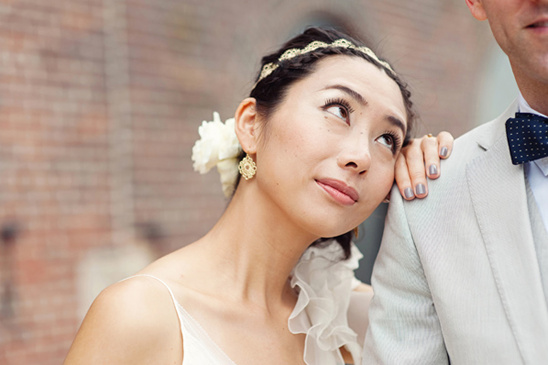 Bride rests head on groom's shoulder looking upward