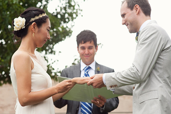 Bride and groom exchanging rings at outdoor wedding