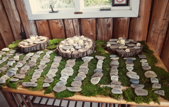 Rustic wedding seating chart with moss and rocks