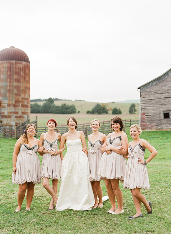 Bride with bridesmaids at rustic country wedding location