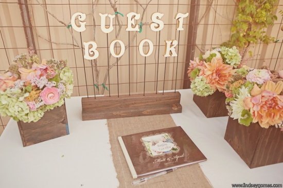 Wedding guest book display with flowers and rustic decor