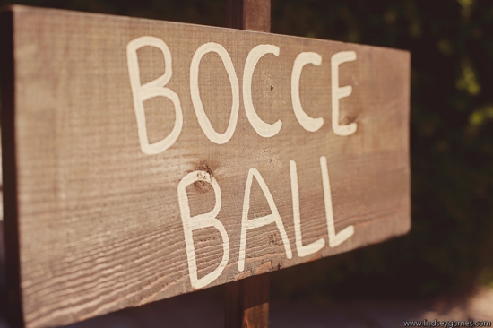 Rustic wood sign reads Bocce Ball in white letters