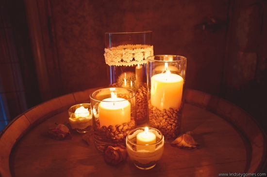 Candles in glass vases on a wooden barrel table