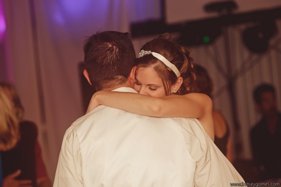 Bride lovingly embraces groom during their first dance