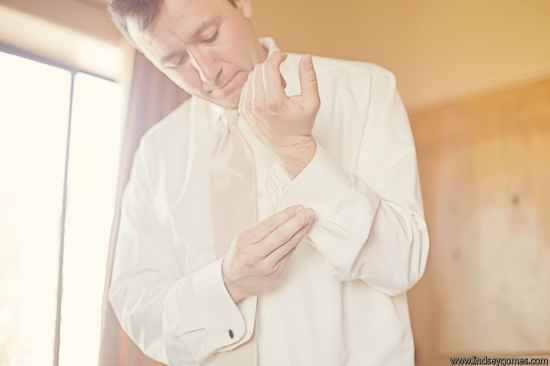 Man in white shirt adjusting cuff