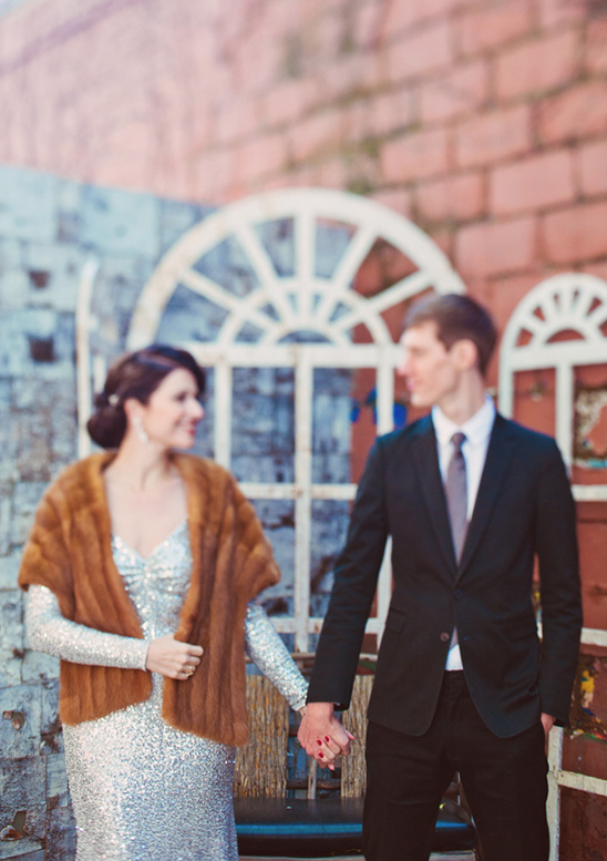 Elegant couple holding hands at wedding venue outdoor