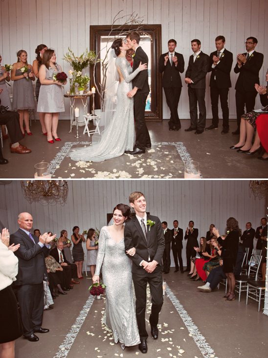 Bride and groom share a kiss at their indoor wedding