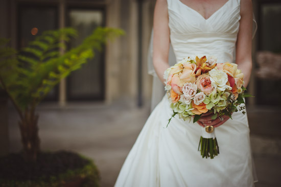 Bride in gown holding a beautiful floral wedding bouquet