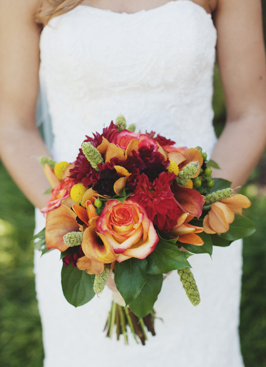 Autumnal wedding bouquet with orange roses and dahlias