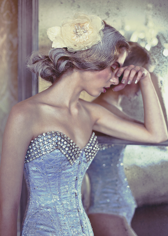 Elegant bride in jeweled blue corset and flower hairpiece
