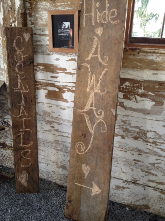 Rustic signs for cocktails and hideaway directions