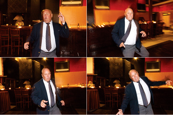 Bald man dances enthusiastically at a bar in four frames