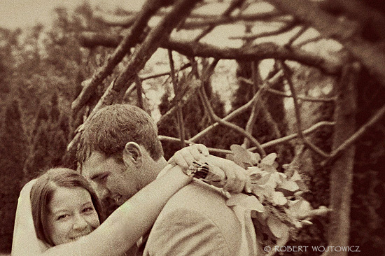 Sepia toned photo of a bride embracing her groom