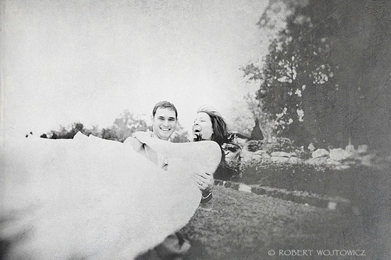 Happy bride and groom joyfully embrace outdoors