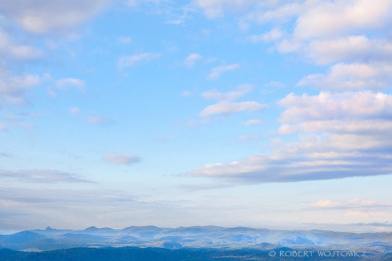 Serene blue sky over hazy mountain range