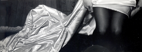 Woman adjusting her satin dress in a vintage photo