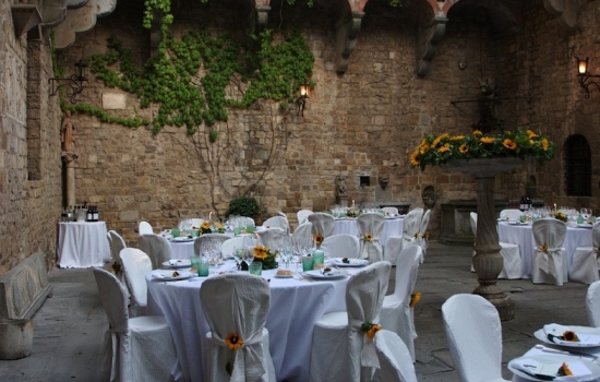 Elegant wedding reception at a rustic stone courtyard venue