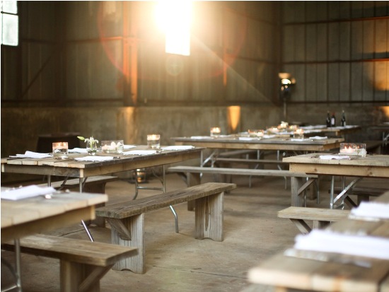 Rustic wedding reception tables and benches indoors