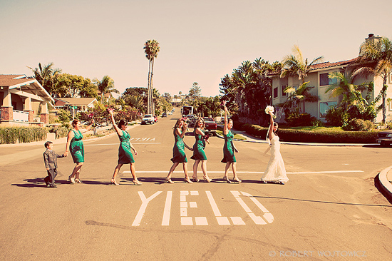 Bride and bridesmaids crossing street, yield sign