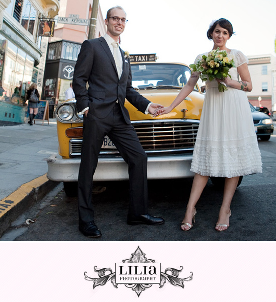 Happy couple posing by yellow taxi for wedding photo