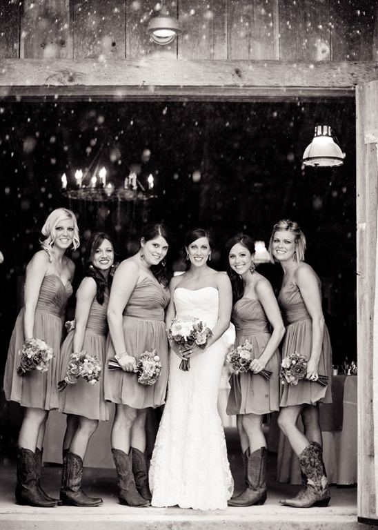 Bride and bridesmaids in cowboy boots at rustic wedding