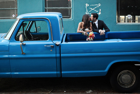 Kissing couple in a blue vintage truck