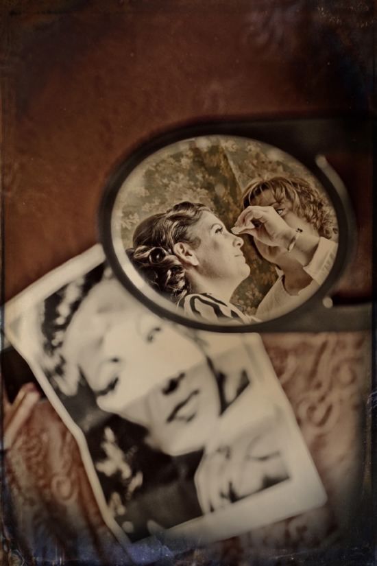 Vintage photo: woman getting makeup applied in mirror