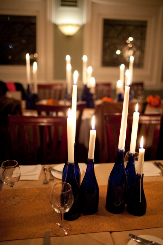 Candles in blue bottles on a table