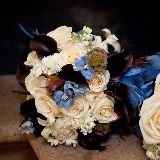 Elegant bouquet with roses calla lilies and blue accents