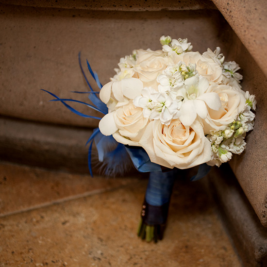 Wedding bouquet roses orchids blue feather accents