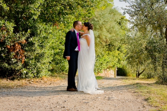 Bride and groom kissing on a country lane