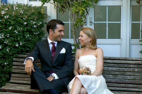 Happy wedding couple sitting on a bench