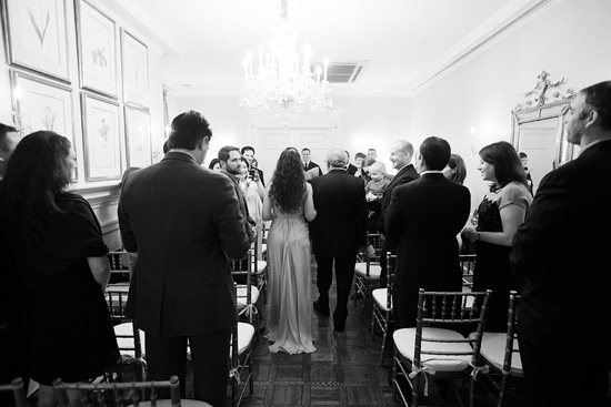 Wedding ceremony guests inside elegant hall