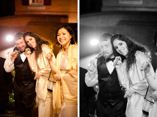 Smiling friends celebrating with cigars at an event