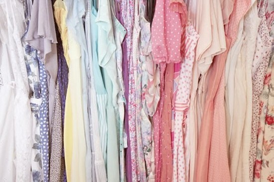 Pastel colored dresses hanging in a closet