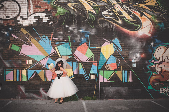 Bride posing in front of graffiti wall art