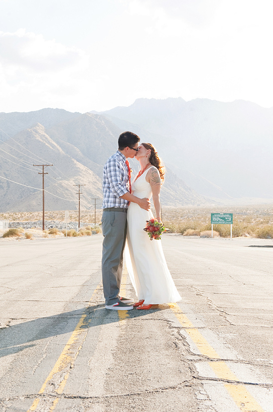 Desert wedding couple sharing a kiss