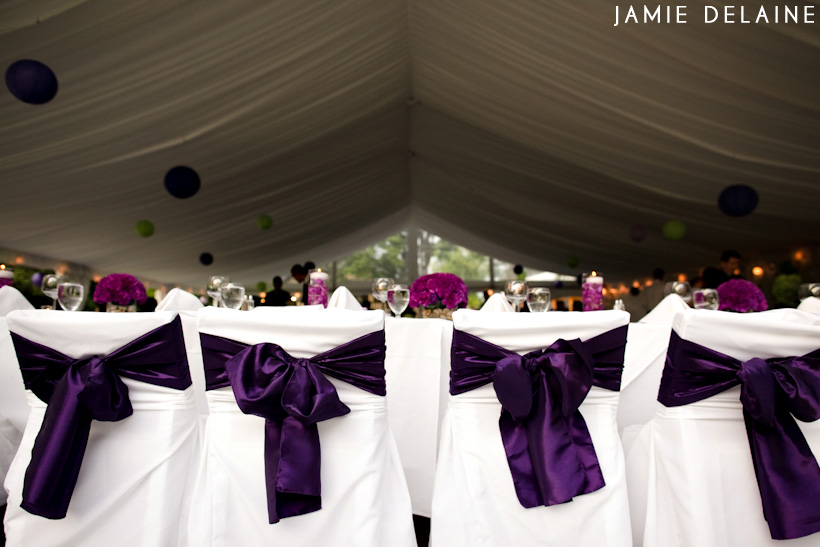 Elegant wedding reception chairs with purple ribbon bows