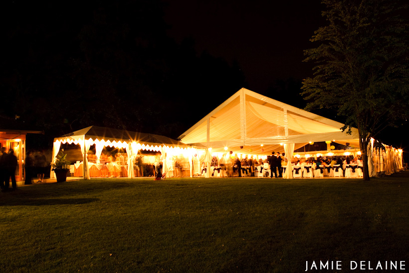 Night wedding reception under illuminated tents