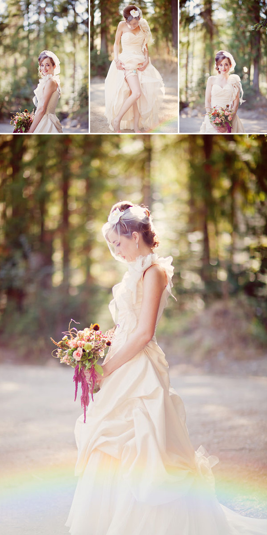 Bride in elegant gown holding flowers in woodland setting