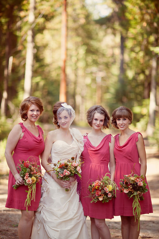 Bride and bridesmaids in coral dresses, outdoor wedding