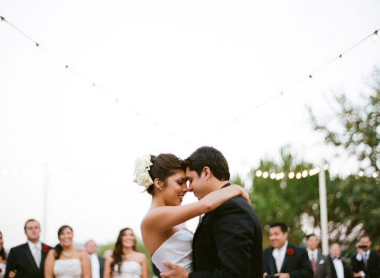 Bride and groom embrace during wedding dance