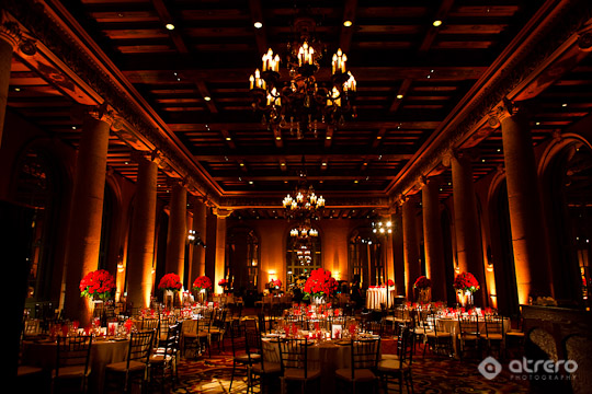 Grand ballroom elegantly decorated with red flowers