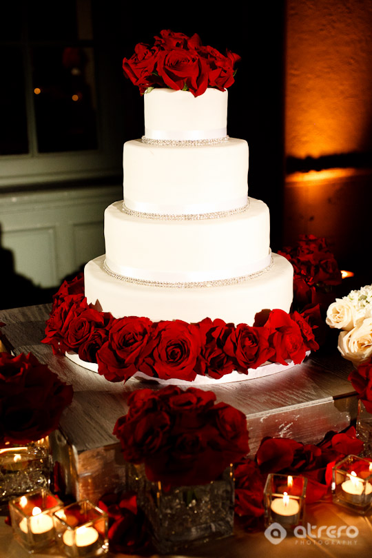 Elegant white wedding cake with red roses