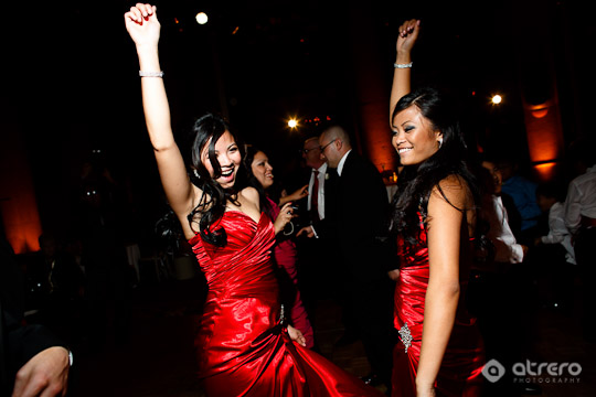 Happy women dancing in red dresses