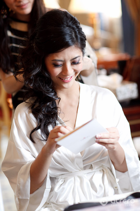 Bride in robe reading wedding message