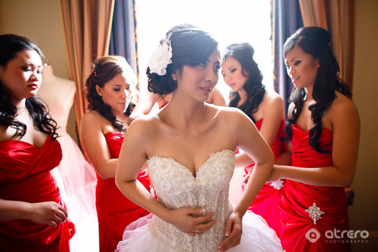 Bride in white dress with red bridesmaids