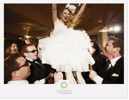 Bride joyfully lifted at wedding reception
